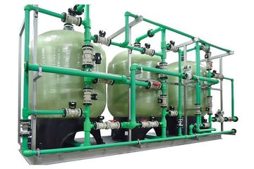 A row of green pipes and tanks