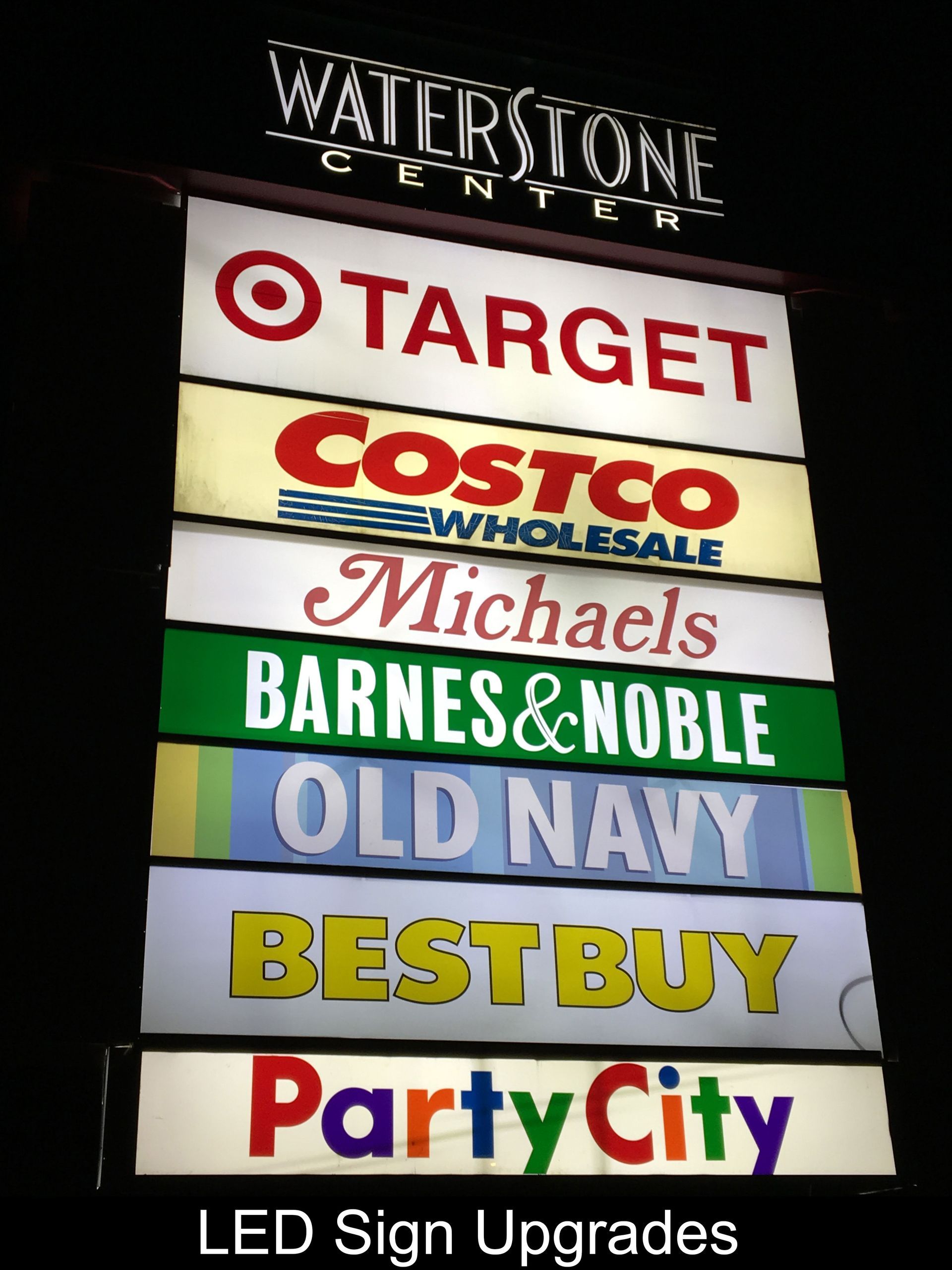 Sign for Waterstone Center listing store logos, including Target, Costco, and Party City.