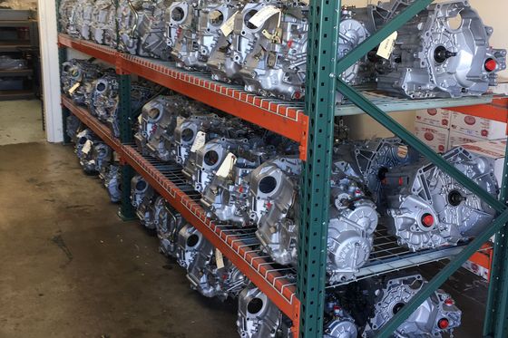 A warehouse filled with lots of engines on shelves.