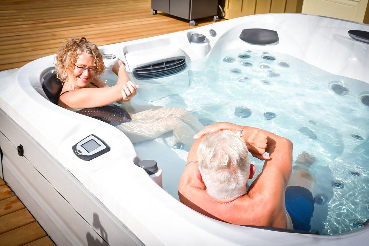 A man and a woman are sitting in a hot tub.