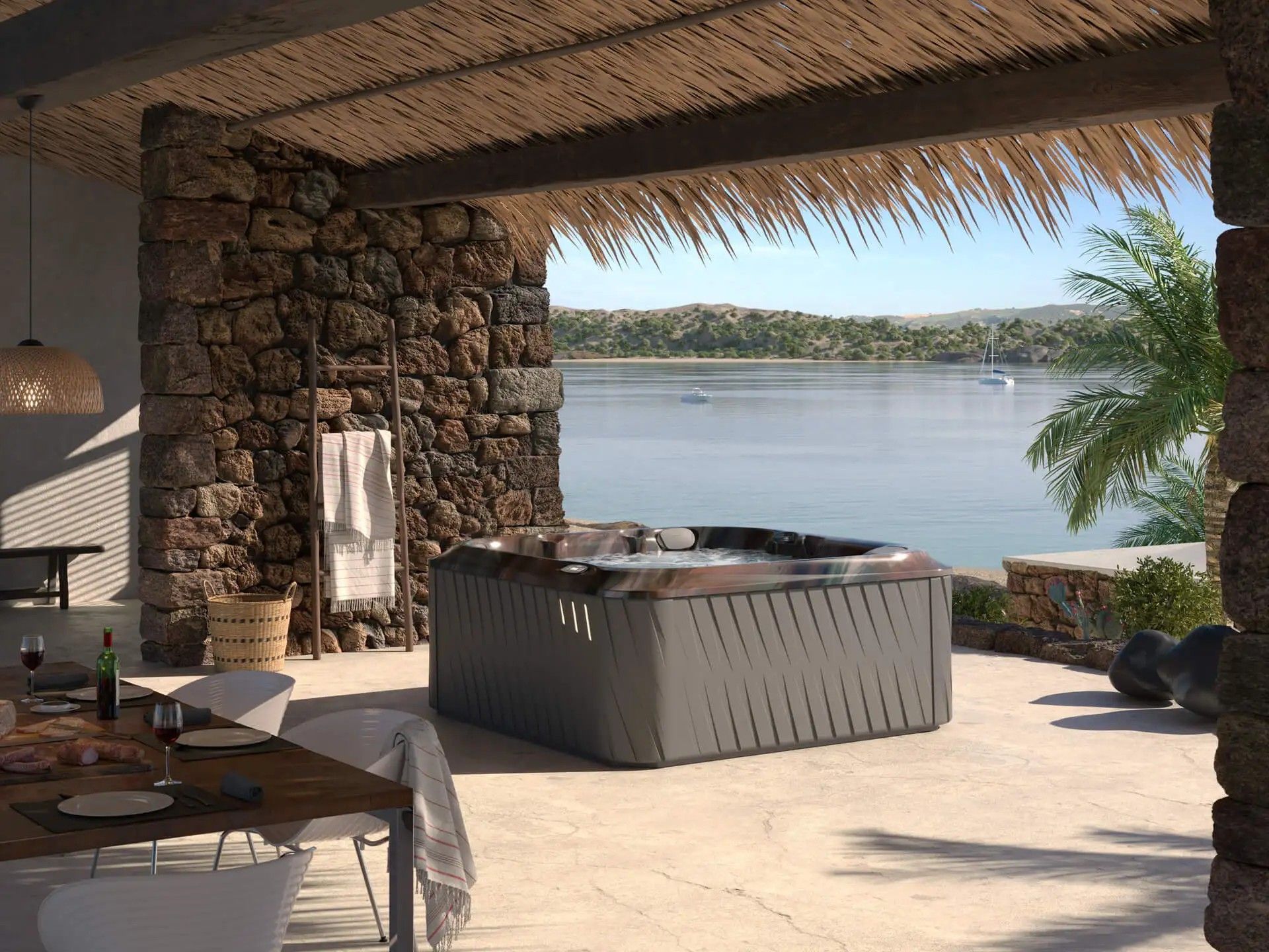 A hot tub is sitting on a patio overlooking a body of water