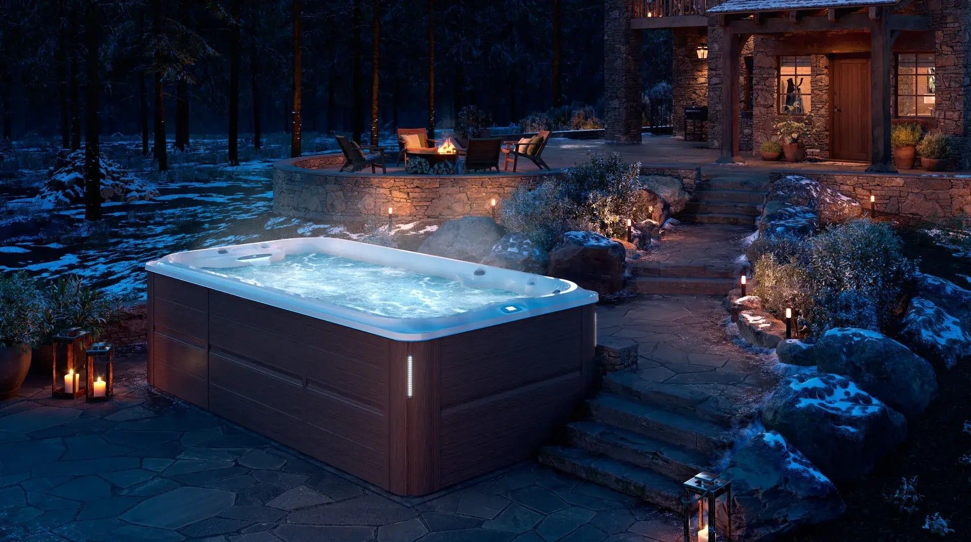 A hot tub is sitting outside of a house at night.