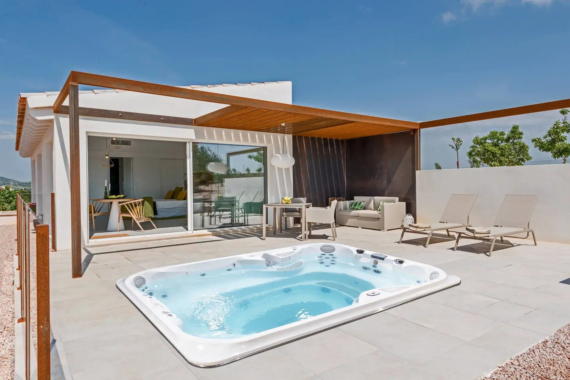 There is a jacuzzi on the patio of a house.