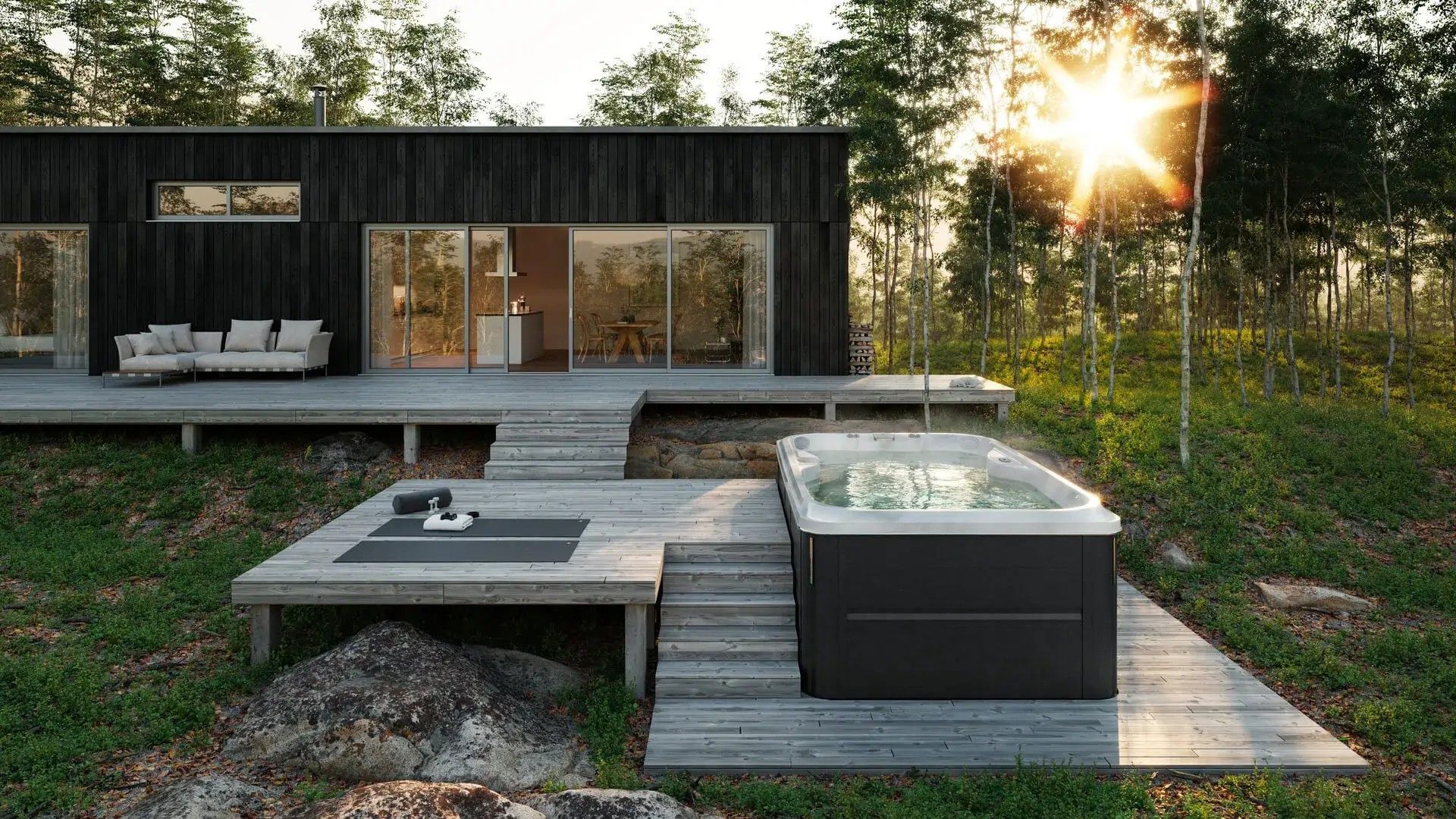 A hot tub is sitting on a wooden deck in front of a house.
