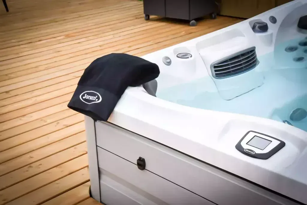 A white hot tub is sitting on a wooden deck.