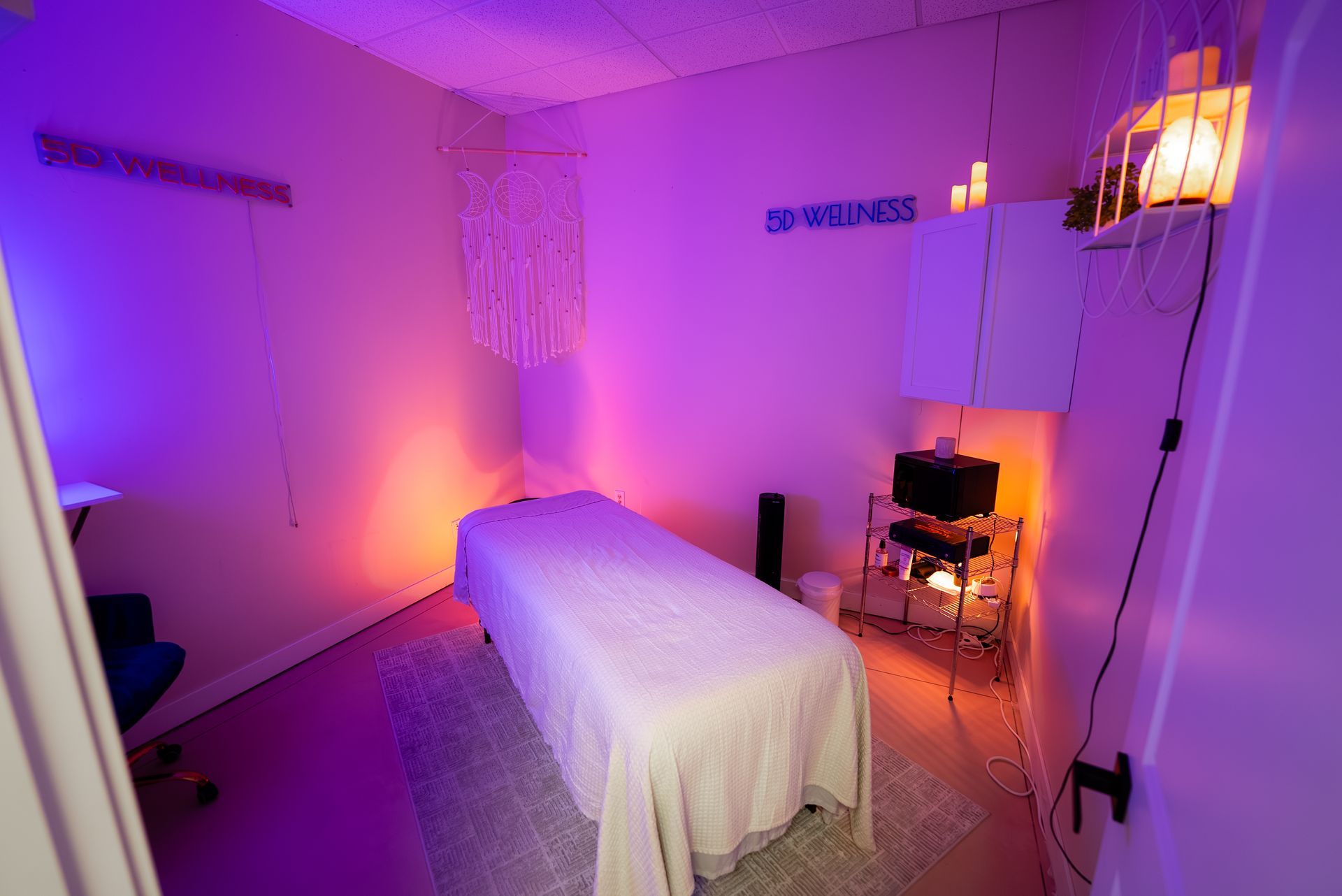 Massage room with purple and orange ambient lighting