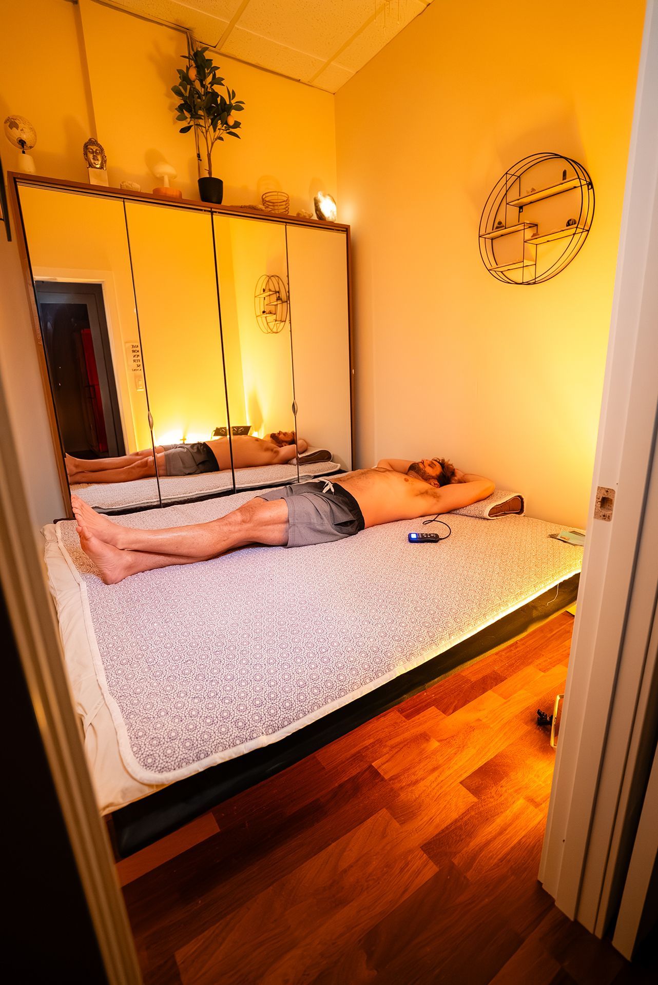Man lying on a bioacoustic mat