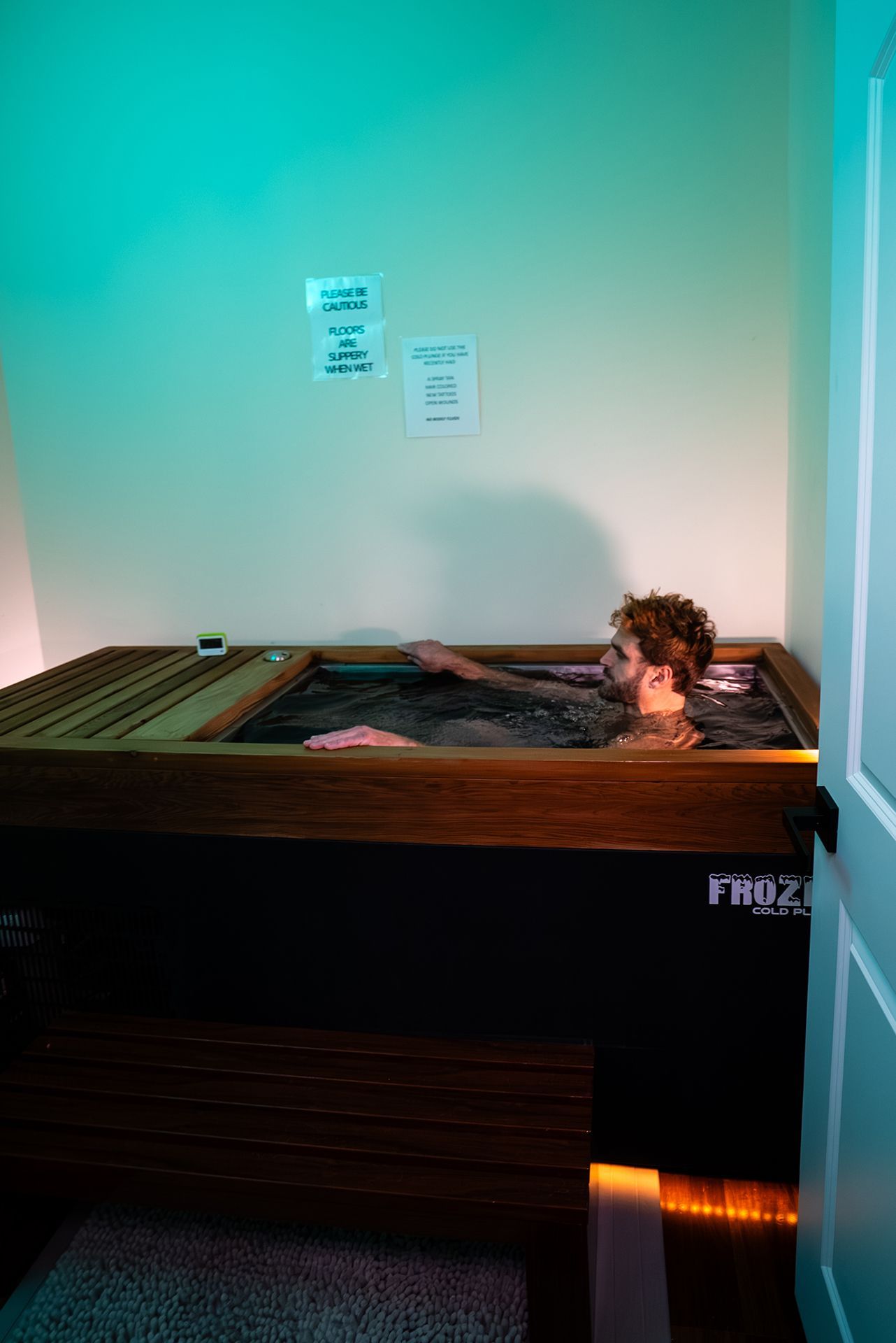 Man sits in a cold plunge tub