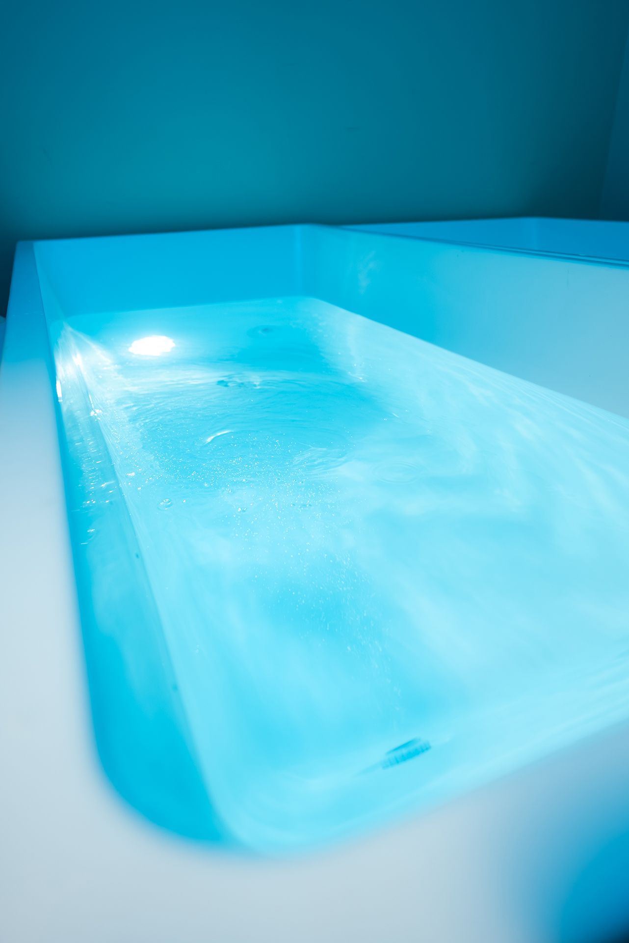 Blue-lit tubs filled with water