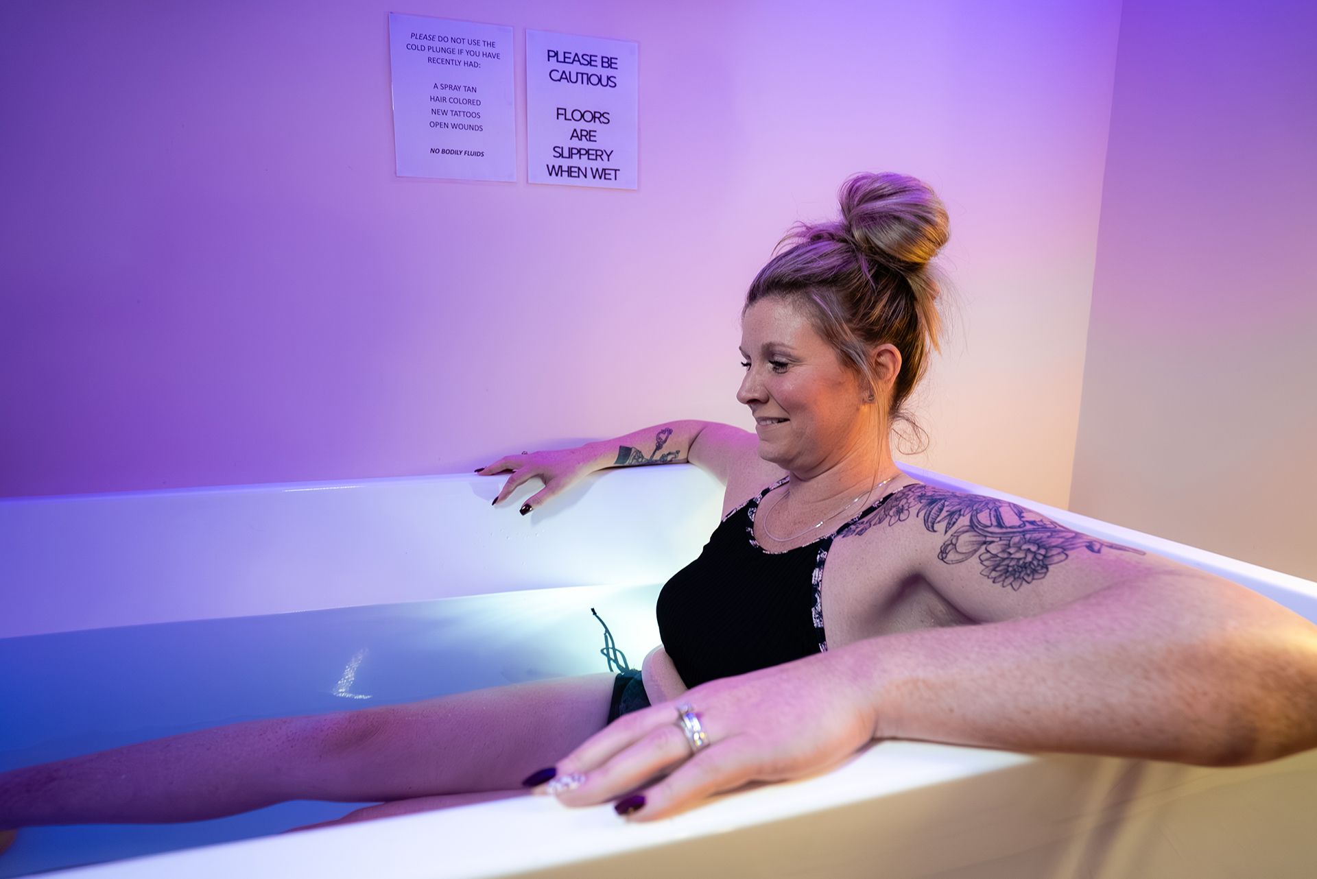 Woman in a tub with arms outstretched
