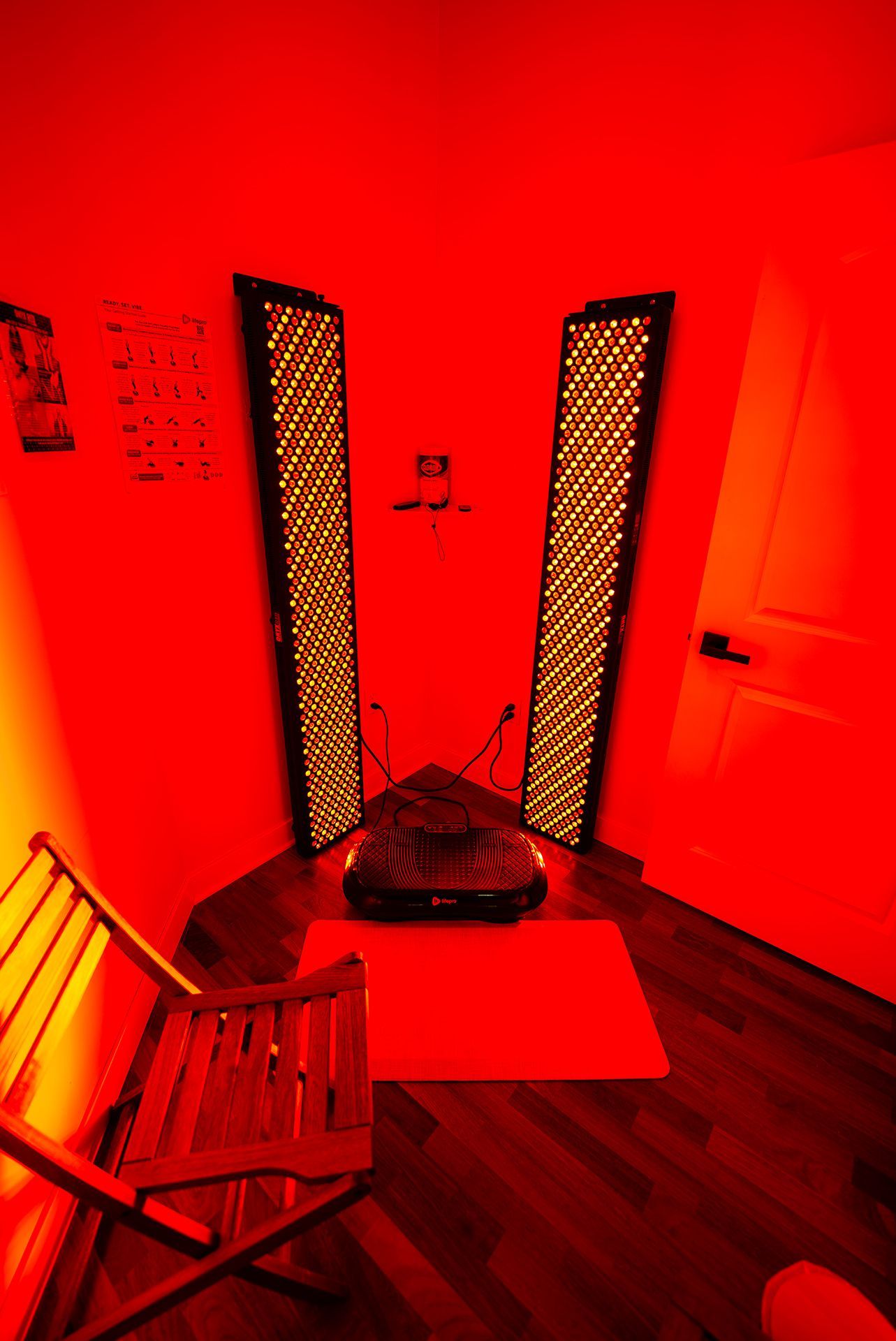 Red-lit room with two tall light panels