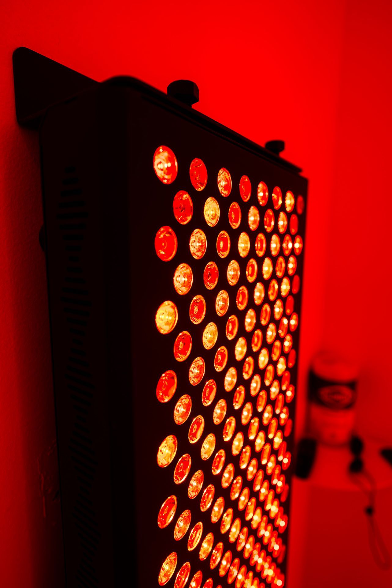 Close up of an infrared panel emitting red light