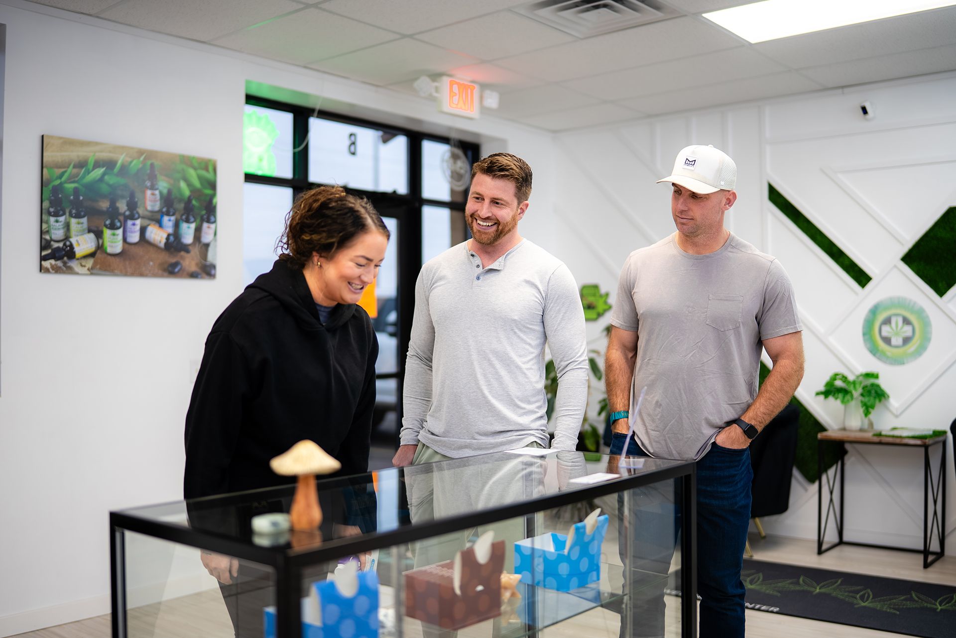 Three people looking at display case