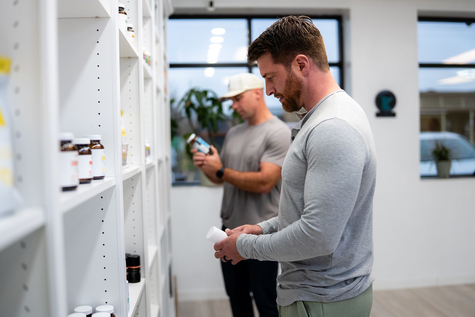 Two men looking at products on shelves in a store