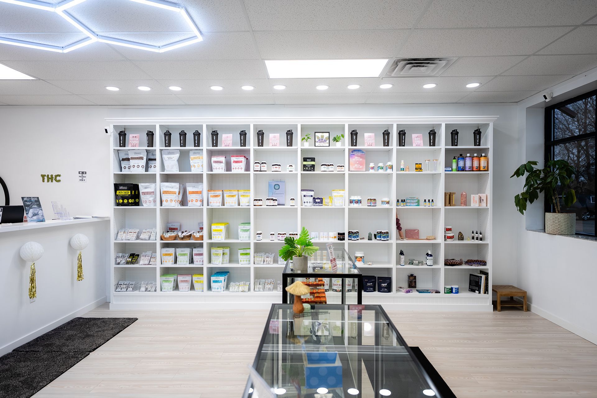 Interior of a store with white shelves filled with products