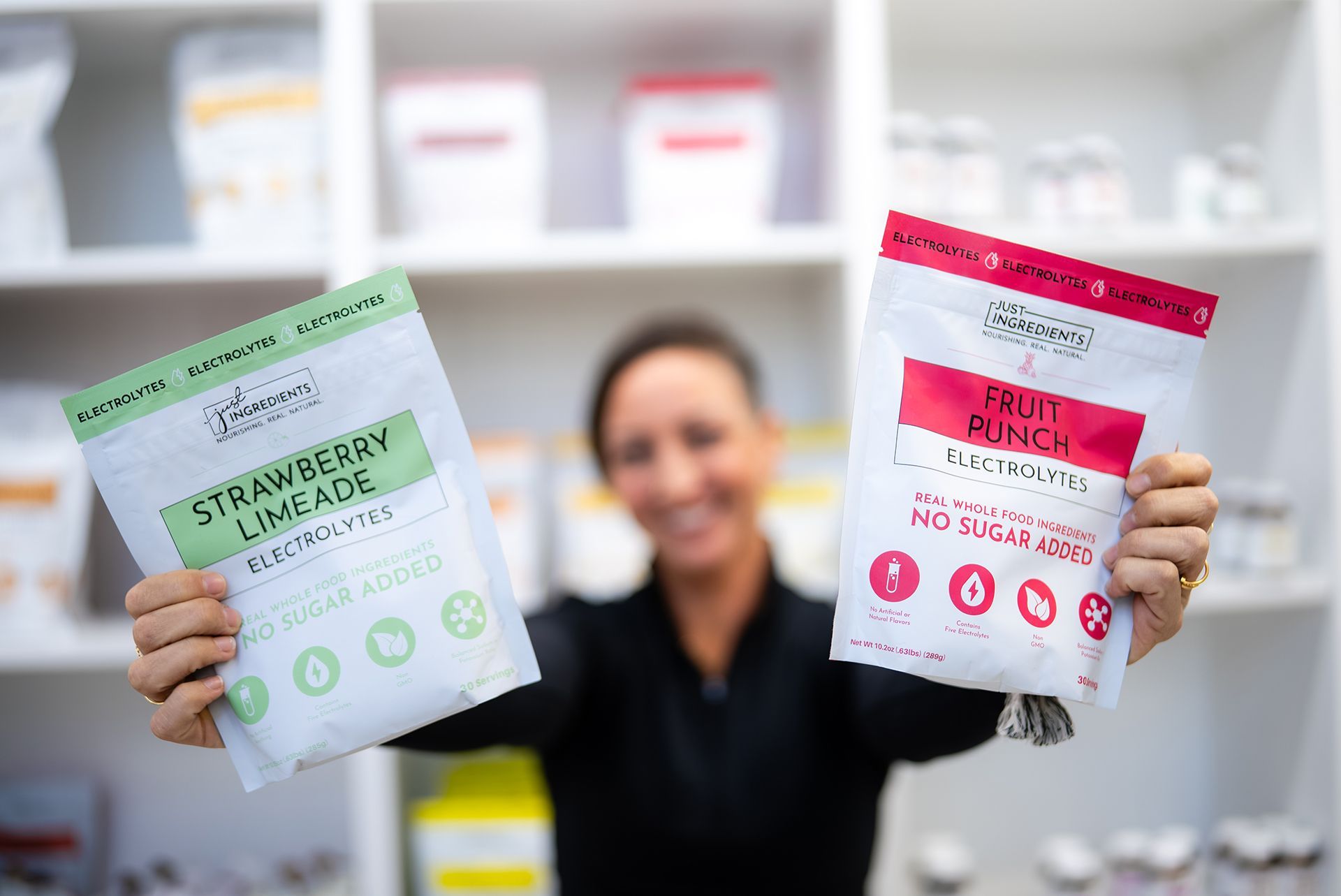 Woman holding Strawberry Limeade Electrolytes and fruit Punch Electrolytes