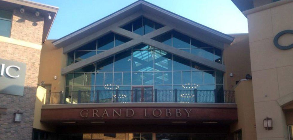 Grand Lobby entrance with large glass windows and brown signage.