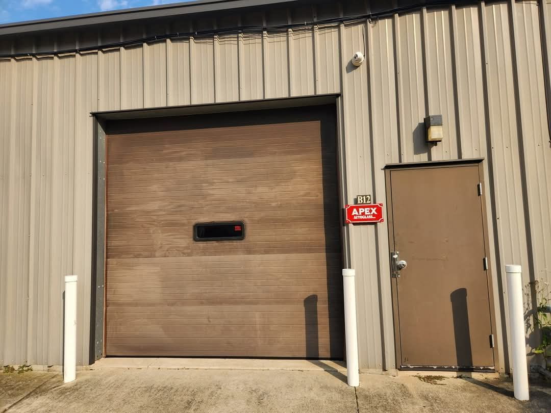 A building with a garage door and a doorway.