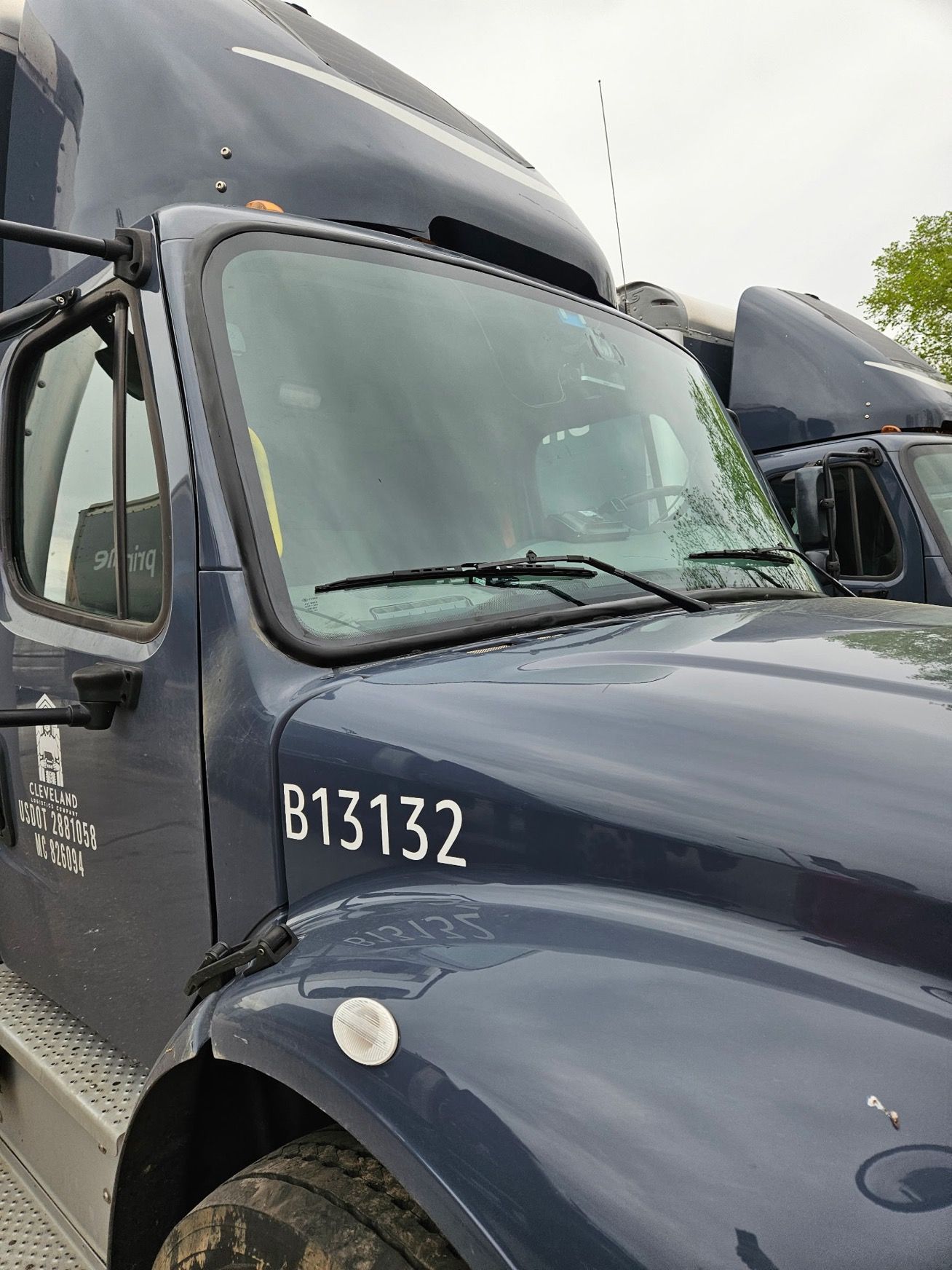 A blue semi truck with the numbers b1312 on the hood.