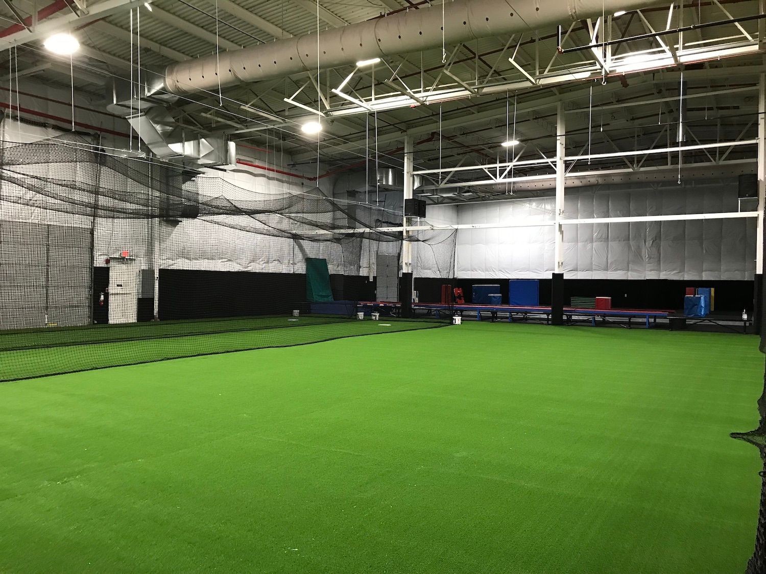 A large indoor stadium with a lot of green grass.