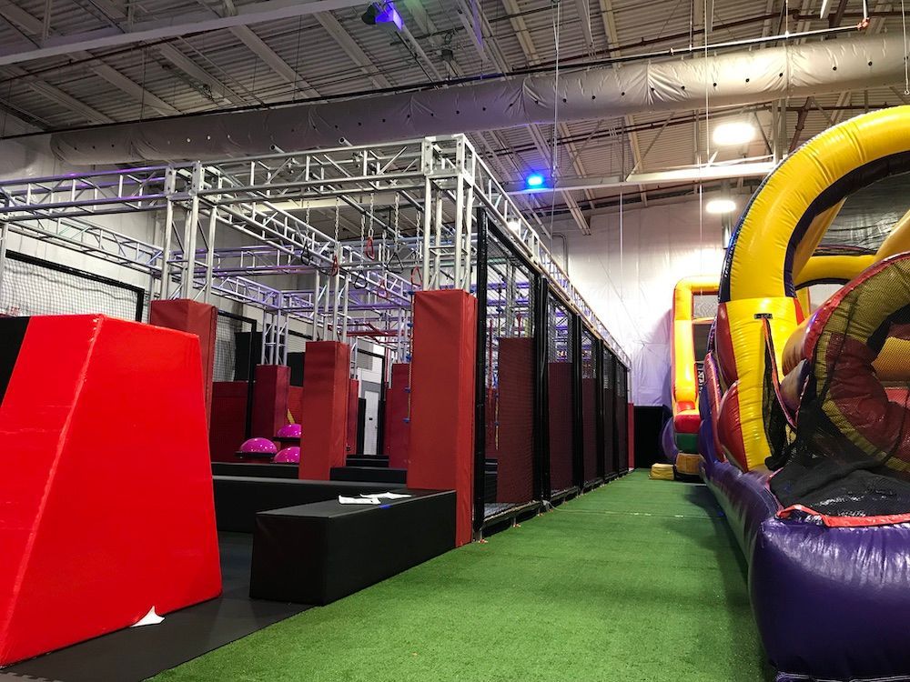 A large inflatable obstacle course in a large building.