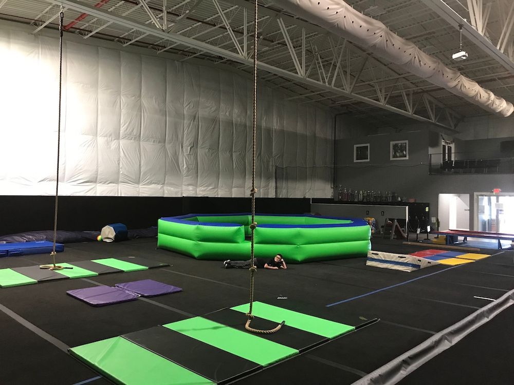 There is a rope swing in the middle of the gym.