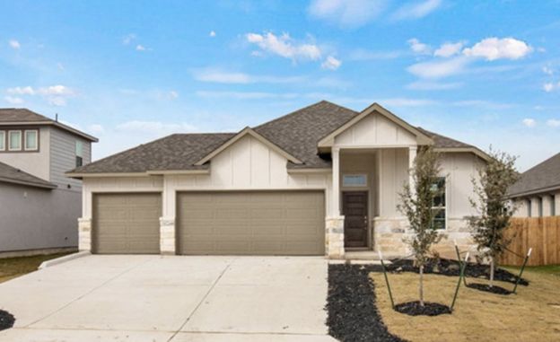 Modern single-story suburban house with three-car garage, light stucco exterior, and a small front yard under a blue sky