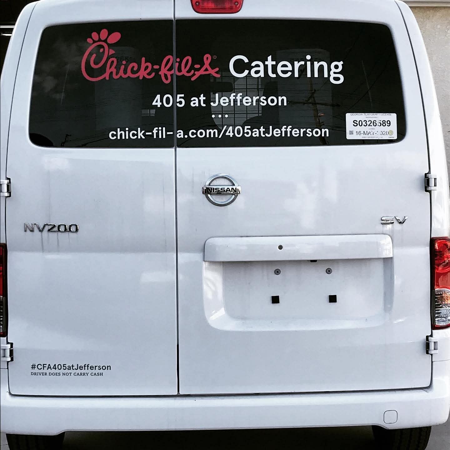 White Chick-fil-A catering van parked, rear view with logo and 405 Jefferson address.