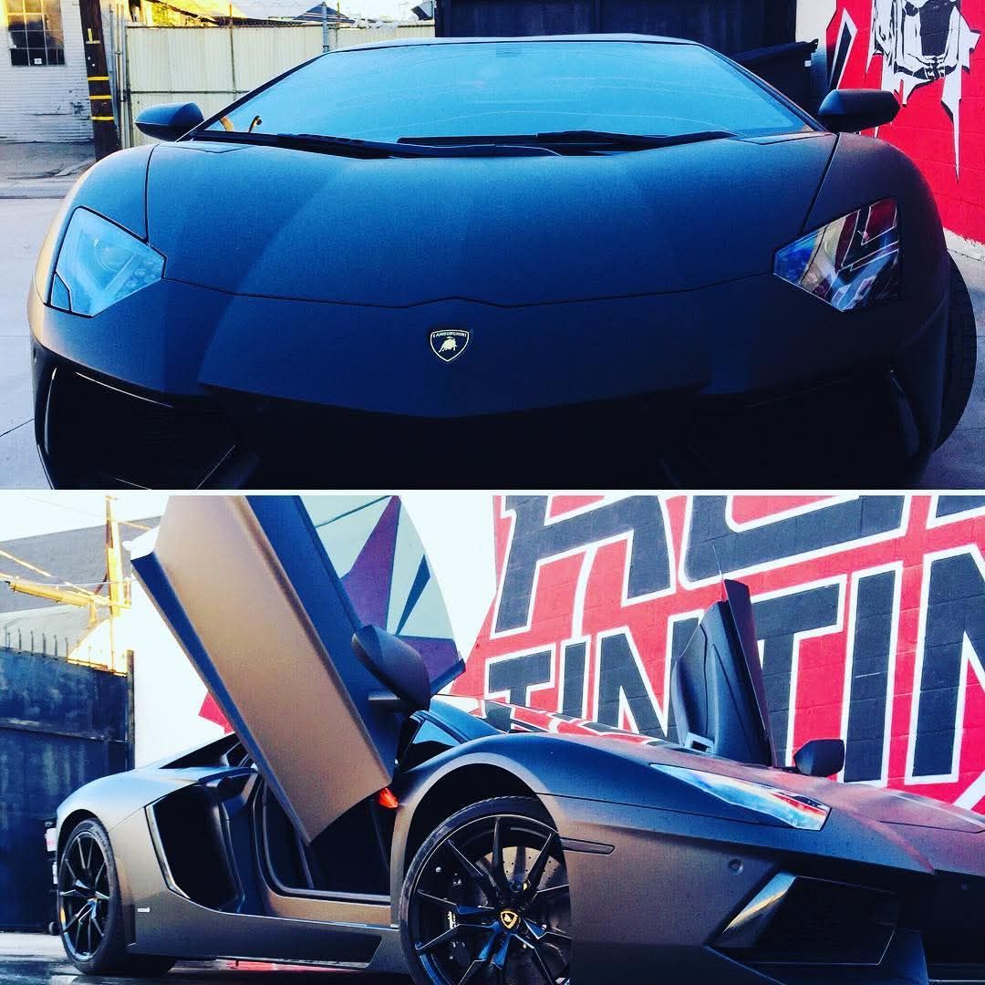 Black Lamborghini in a showroom, shown front view and side view with scissor doors open