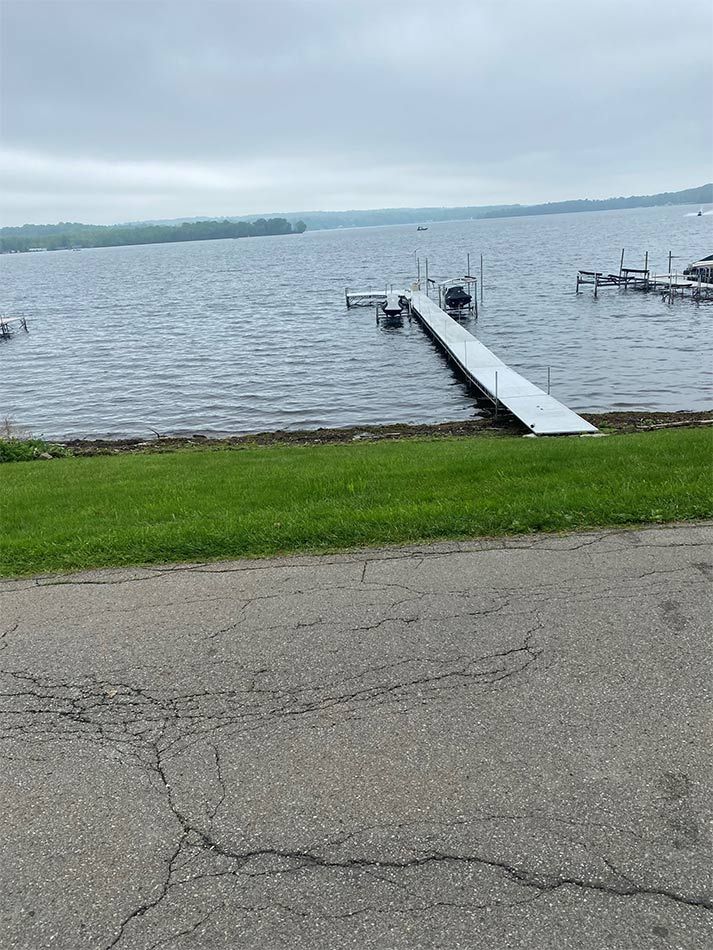A large body of water with a dock in the middle of it.