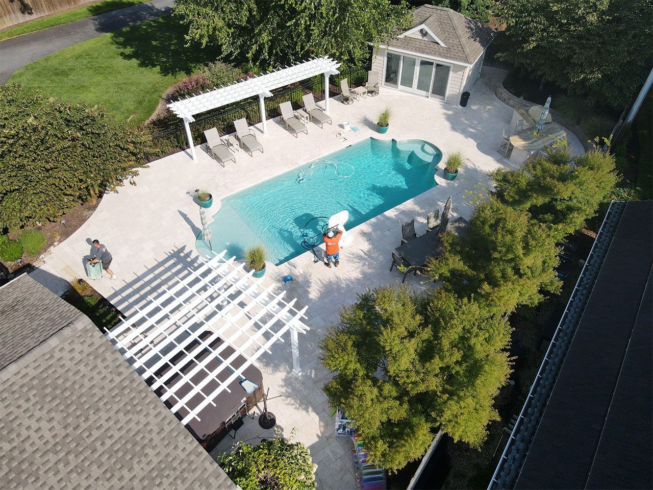 An aerial view of a large swimming pool in a backyard