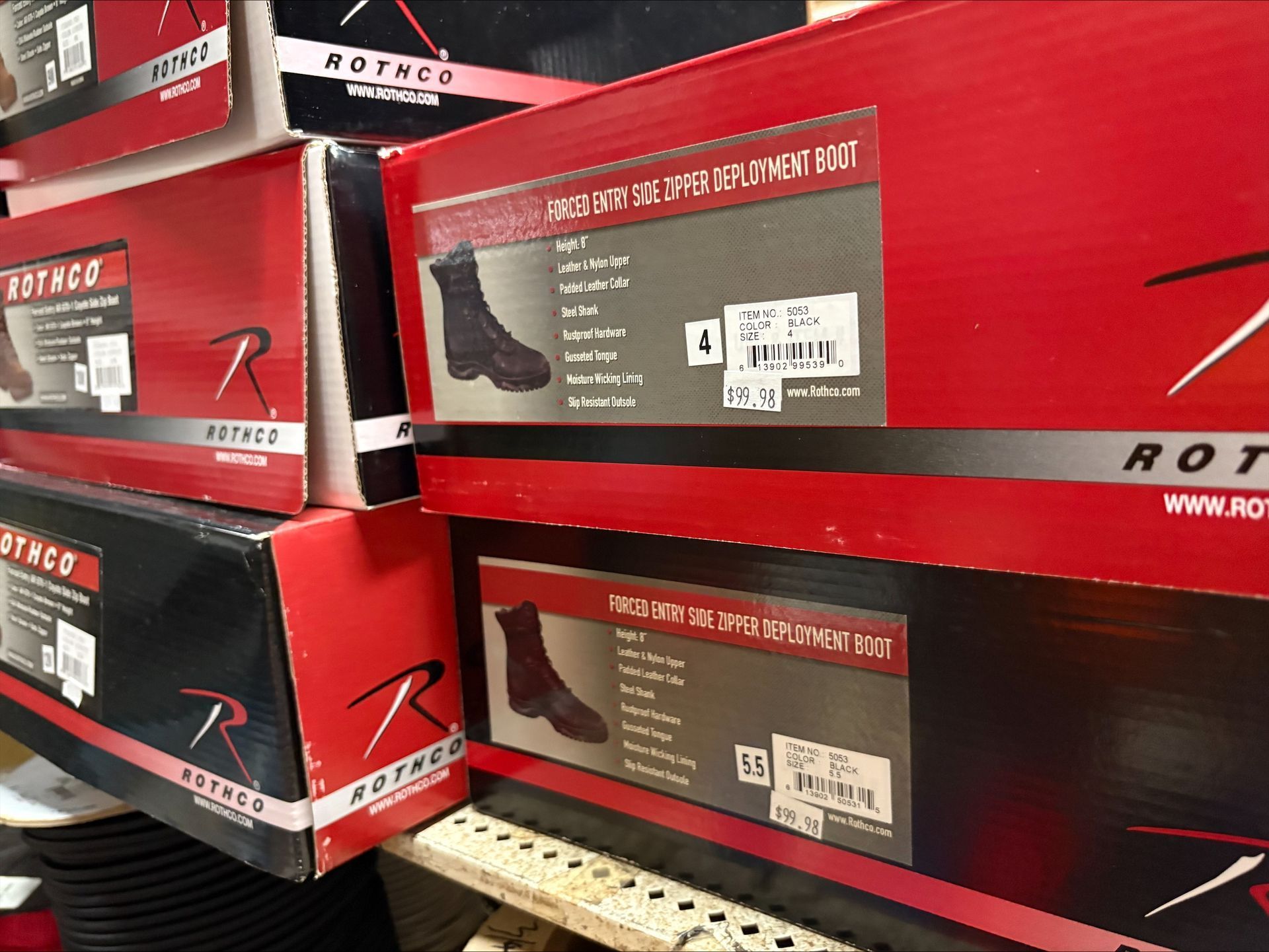 Boxes of Rothco boots stacked on a shelf, red and black.