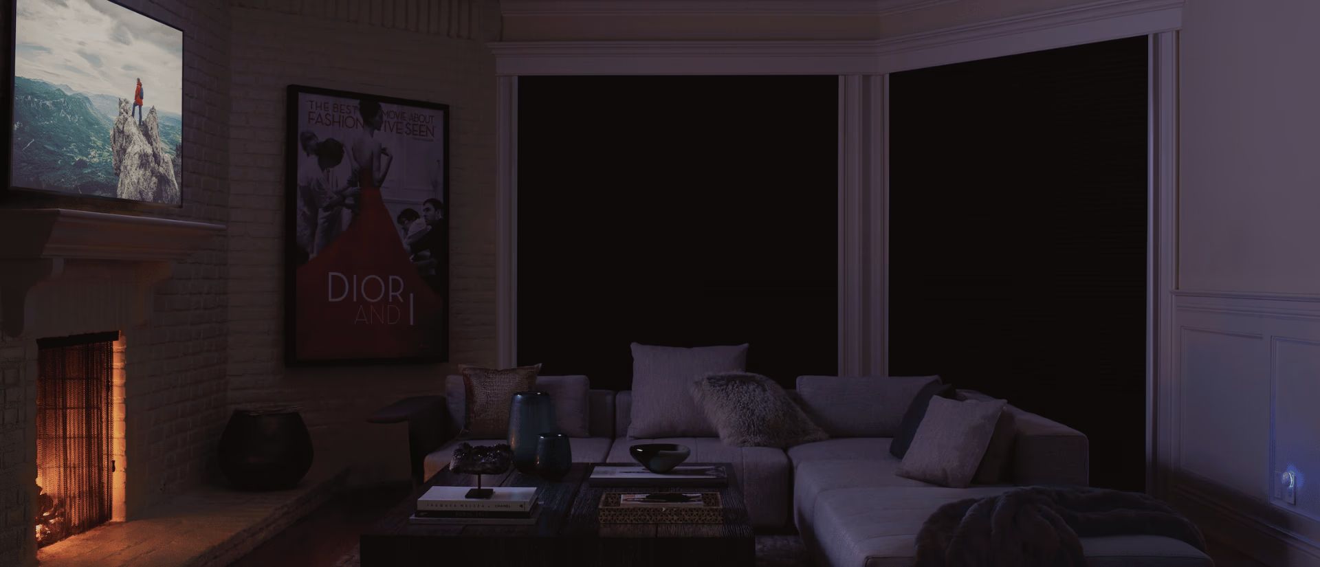 Dim living room with fireplace, sofa, coffee table, and large dark windows at night
