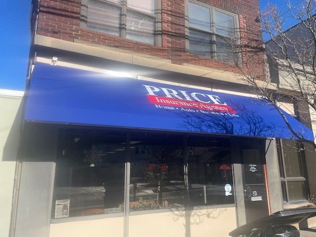 A storefront with a large blue awning that reads 