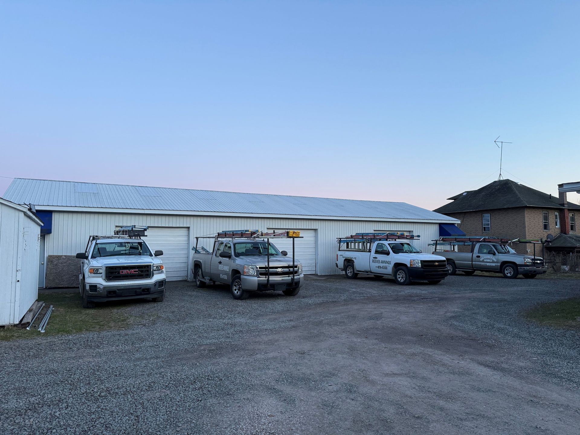 Black and white striped awning over a building entrance with a Michael Kors advertisement.