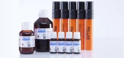 Assorted lab chemical bottles and orange test tubes with black caps on a white background.