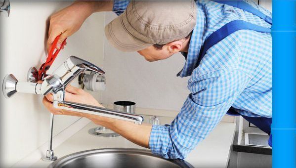 Plumber fixing faucet