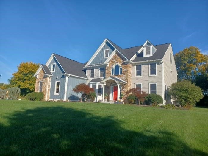 Front view of a house with brick design and siding