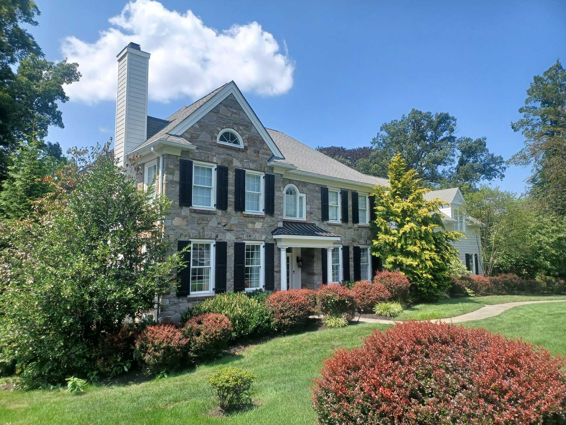 beautiful two-story house with a chimney and rock siding design