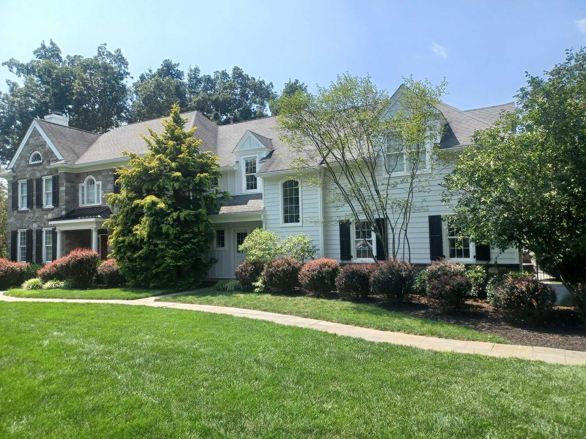 beautiful two-story house with louvered exterior shutters