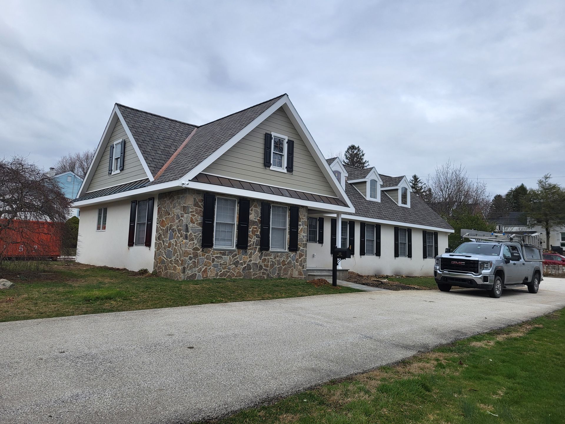 A white house with a truck parked in front of it