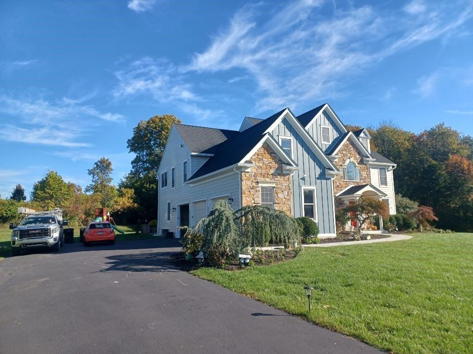 Side view of a house with brick design and siding