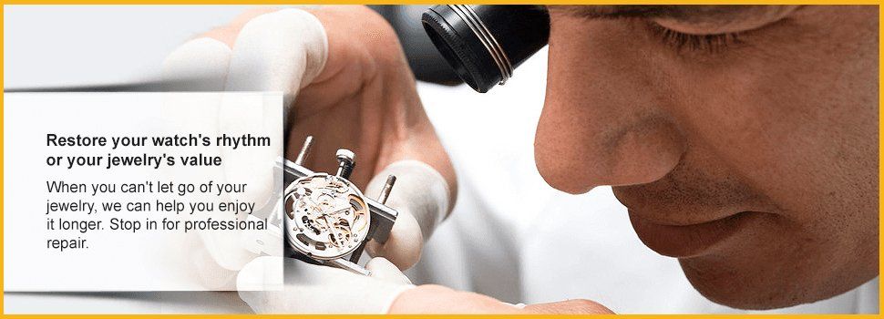 Jeweler with loupe working on watch