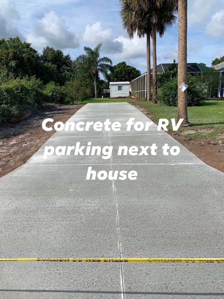 Concrete RV parking next to house, with caution tape and trees.