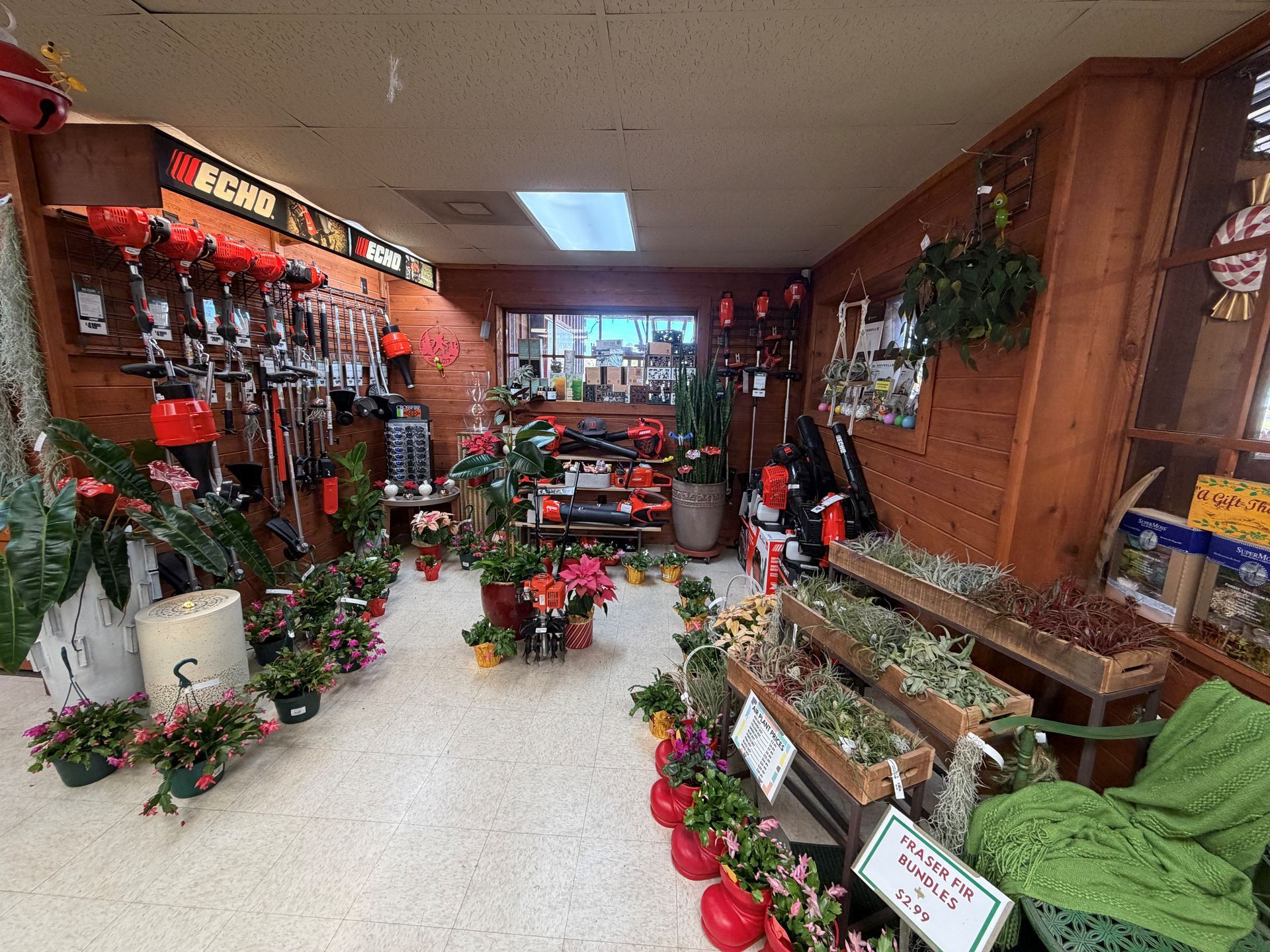 Inside a flower shop, rows of plants and gardening tools on display, wood-paneled walls.