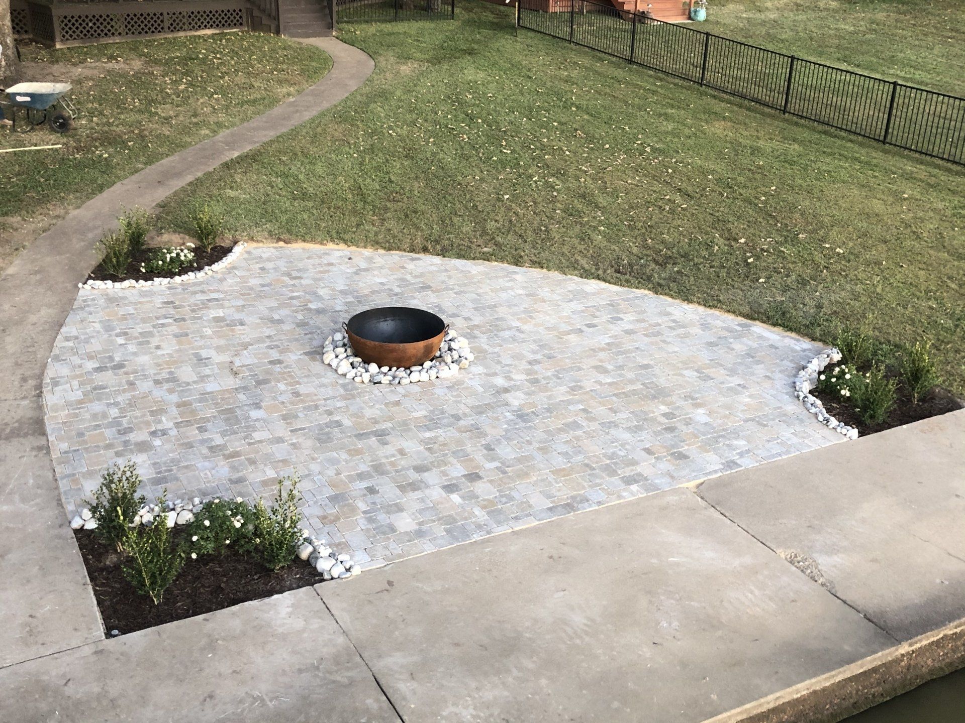 There is a fire pit in the middle of the patio.