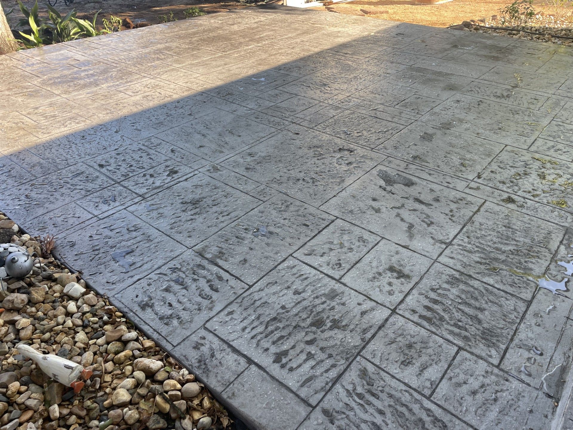 A close up of a concrete driveway with a pattern on it.