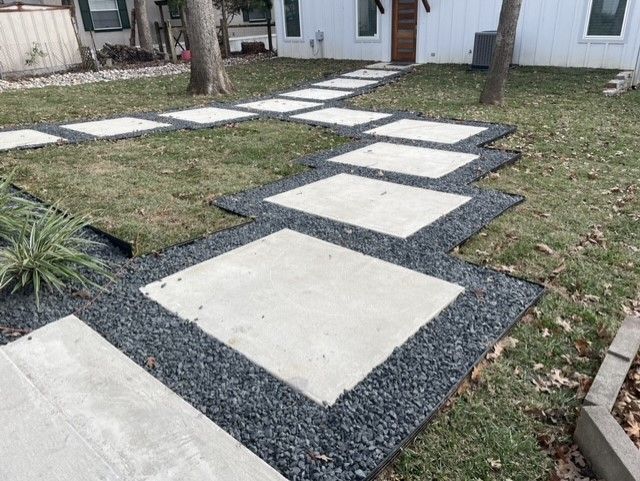 a concrete walkway leading to a white house .
