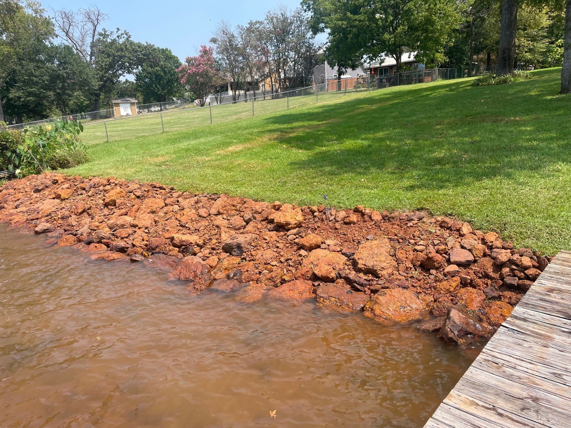 A wooden dock is sitting next to a body of water