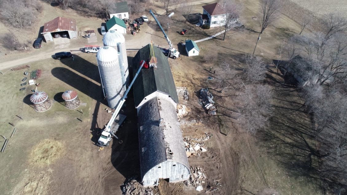 An aerial view of a farm with silos and a barn
